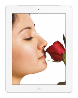 Image of an iPad showing an image of a young woman smelling a rose